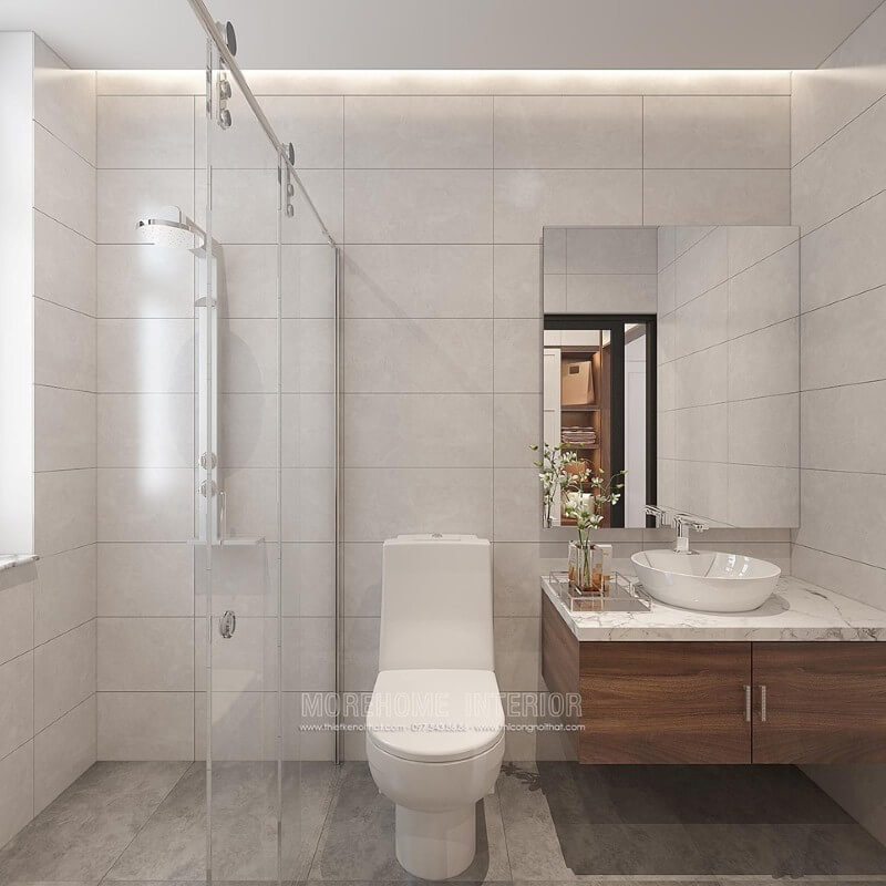 Thiết kế phòng tắm chung cư theo phong cách hiện đại đẹp với cách lựa chọn đồ vật tinh gọn nhưng lại tạo vẻ đẹp sang trọng cuốn hút từ tường ốp gạch giả bê tông, gương hiện đại không khung ốp tường, phòng tắm kính cửa trượt. Thiết kế nội thất chung cư